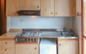 a kitchen with a stove and a sink at Beautiful Apartment In Bibione With Outdoor Swimming Pool in Bibione