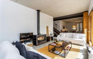 a living room with a white couch and a fireplace at Cozy Home In Ariany With Outdoor Swimming Pool in Ariany