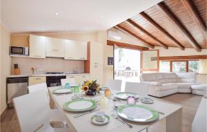 a kitchen and living room with a table and chairs at Villa Ginestra in Acquavella +19 photos