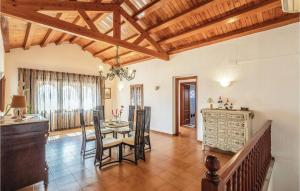 a kitchen and dining room with a table and chairs at 8 Bedroom Amazing Home In Riudellots in Riudellots de la Selva