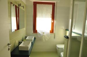 a bathroom with a sink and a toilet and a window at Domus Primavera in Scerne +23 photos