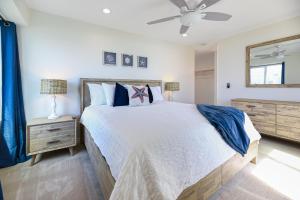 a bedroom with a bed and a ceiling fan at D313 - Sea Blue in Oceanside +46 photos