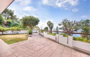 an outdoor walkway with a white fence and trees at Villa Sarah in Ioppolo