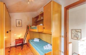 a bedroom with two bunk beds and a ladder at Cozy Apartment In Marignana lu With Kitchen in Corsanico-Bargecchia