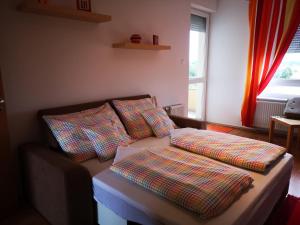 a couch with pillows on it in a living room at Mészáros apartman in Bük