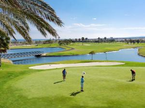 a group of people standing on a golf course at Castillo Mar 87 in Caleta De Fuste
