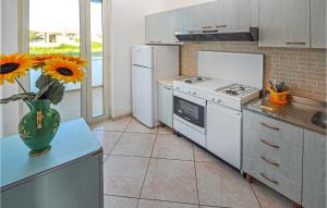 a kitchen with a vase of sunflowers on a counter at Awesome Apartment In Gallipoli With 3 Bedrooms in Gallipoli
