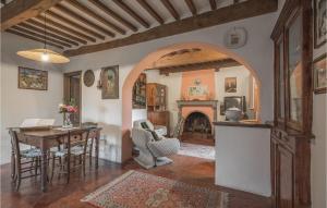 a living room with a table and a fireplace at Beautiful Home In Bagni Di Lucca Lu With Outdoor Swimming Pool in Bagni di Lucca
