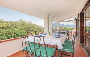 a patio with a table and chairs on a balcony at Villa Ars Mediterranea in Scario