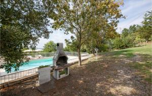 a backyard with a stone oven next to a swimming pool at Nice Apartment In Pieve Di Santa Luce in Pieve di Santa Luce +8 photos
