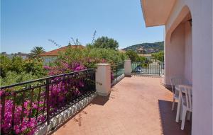 a balcony with purple flowers and a fence at Casa Borgo 2 in Pietra Ligure