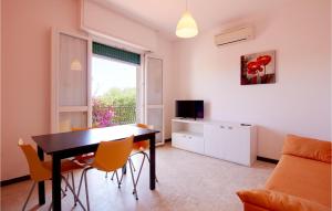 a living room with a table and chairs and a television at Casa Borgo 2 in Pietra Ligure