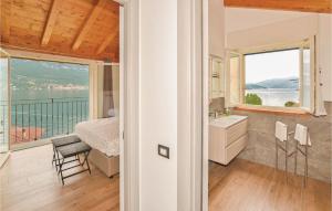 a bathroom with a bed and a sink and a window at Pescau House in Lezzeno +4 photos