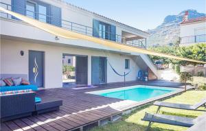 a house with a swimming pool in the backyard at Amazing Home In Calenzana With House A Mountain View in Calenzana