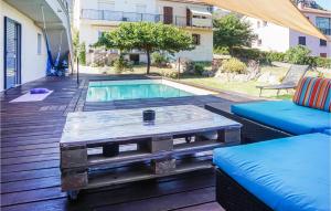 a coffee table on a deck next to a pool at 3 Bedroom Awesome Home In Calenzana in Calenzana +9 photos
