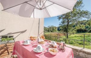 uma mesa com uma toalha de mesa rosa e um guarda-chuva em Vigna Marengo em Varese Ligure