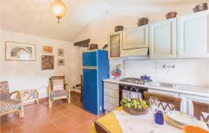 a kitchen with a blue refrigerator and a table at Casa Lina in Comano
