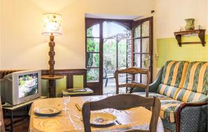 a living room with a couch and a tv at Le Colibri in Gourfaleur