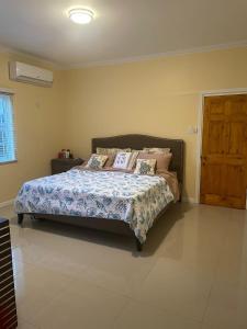 a bedroom with a bed and a wooden door at paradise cove in Spanish Town +25 photos