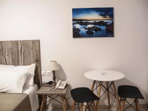 a bedroom with a bed and a table and a phone at Fragoulis Village in Parasporos