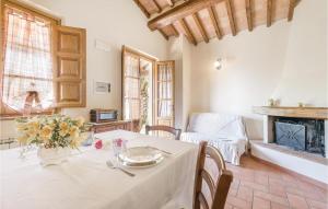 a dining room with a table and a fireplace at Casina Giardino in Lamporecchio