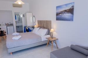 a bedroom with a bed and a living room at Fragoulis Village in Parasporos