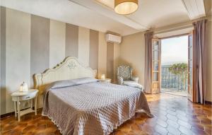 a bedroom with a bed and a large window at 2 Bedroom Awesome Home In Priocca in Priocca