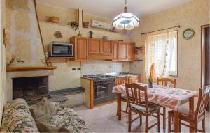 a kitchen with a table and a stove top oven at Nice Apartment In Bivongi With Wifi And 1 Bedrooms in Bivongi