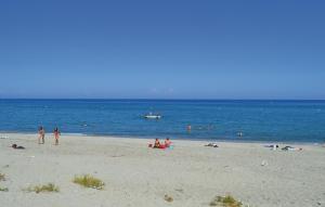 a group of people on a beach near the water at Nice Apartment In Moriani Plage in Moriani Plage