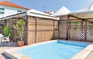 a swimming pool in a backyard with a wooden fence at Casa Borgo 3 in Pietra Ligure