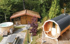 a large wooden cabin with a tub in a yard at Awesome Home In Basse-Sur-Le-Rupt in Basse-sur-le-Rupt