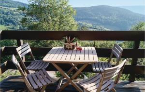 a wooden table and chairs on a deck with a potted plant at Awesome Home In Basse-Sur-Le-Rupt in Basse-sur-le-Rupt