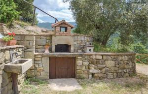 a stone building with a door and a bird house on top at Casa Di Vigna Rosa in Serravalle