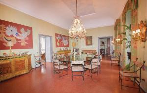 a dining room with a table and chairs and a chandelier at Villa Ghislanzoni in Calco