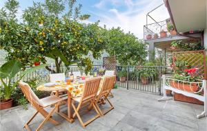 a table and chairs on a patio with an orange tree at Casa Flora in Dolcedo