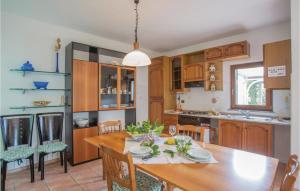 a kitchen and dining room with a wooden table at Casa Virginio in Pomonte