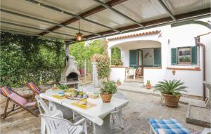 an outdoor patio with a table and a fireplace at Casa Virginio in Pomonte