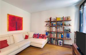 a living room with a couch and a book shelf at Beautiful Apartment In Venezia -ve- With 2 Bedrooms And Wifi in Venice