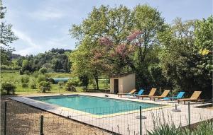 una piscina in un cortile con sedie intorno di Cozy Home In Anduze With House A Mountain View ad Anduze