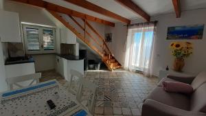 a kitchen and a living room with a table and chairs at Il Quadrifoglio in Massa Lubrense