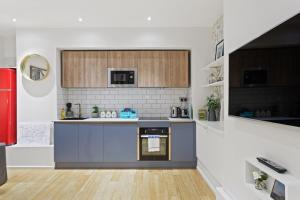 une cuisine avec une cuisinière et un comptoir dans l'établissement Trendy 1 Bedroom Apartment in the Heart of London, à Londres