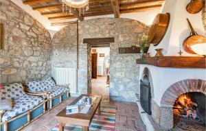 a living room with a couch and a fireplace at La Selvarella in Seggiano