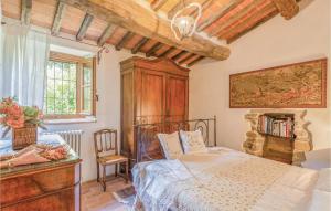a bedroom with a bed and a table and a chair at Casa Al Vento in Battifolle