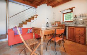 eine Küche mit einem Tisch und Stühlen sowie eine Treppe in der Unterkunft Casetta in Pieve di Teco