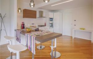 a kitchen with a table with a striped table cloth at Villetta Il Mirto in Belladonna