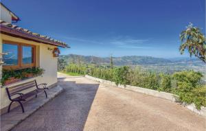 a bench sitting on the side of a house with a view at Casa Frascalino in Montemagno