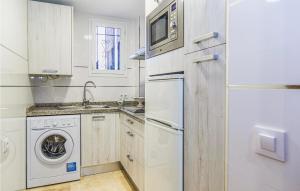 a kitchen with a washer and dryer and a refrigerator at Beautiful Apartment In Crdoba With Kitchenette in Córdoba