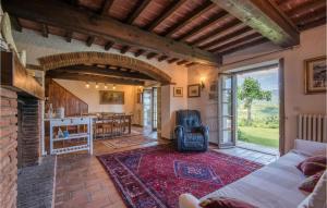 a living room with a couch and a fireplace at 2 Bedroom Gorgeous Home In Capolona in Capolona