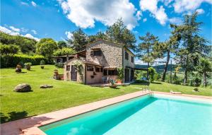 a stone house with a swimming pool in front of it at 2 Bedroom Gorgeous Home In Capolona in Capolona