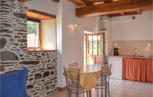 a kitchen and dining room with a table and chairs at Amazing Home In Minihy Treguier With 1 Bedrooms And Wifi in Minihy-Tréguier